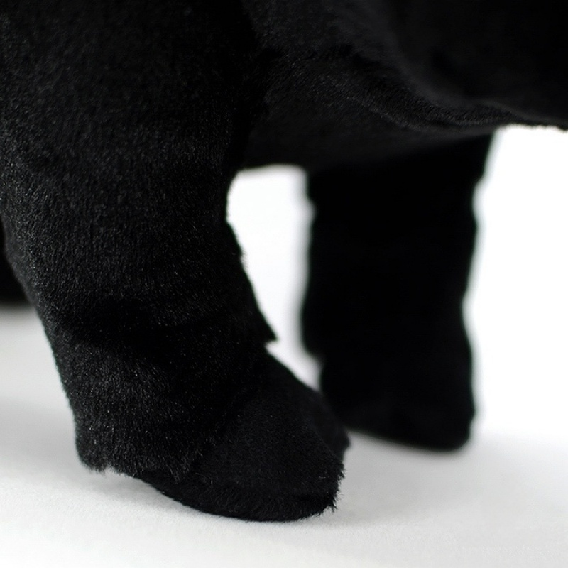 Detailed view of the black pig plush toy’s front leg, showcasing its soft and durable stitching