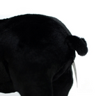 Focused shot of black pig plush toy’s curled tail, adding charm to its lifelike design