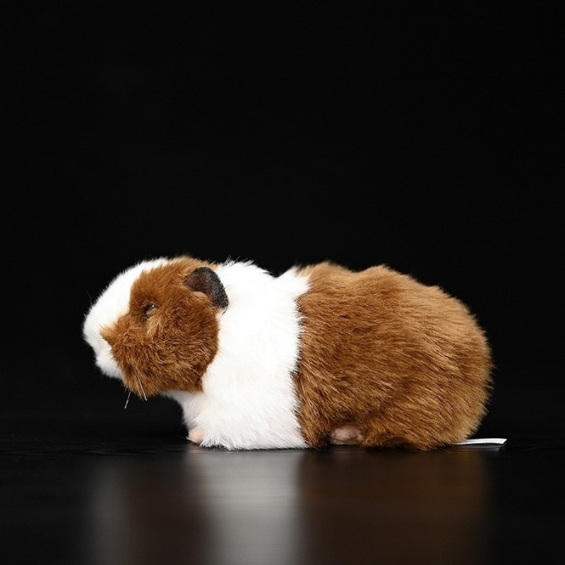 Side profile of a brown and white guinea pig plush toy, featuring realistic fur and cuddly design by SoftDaysLab