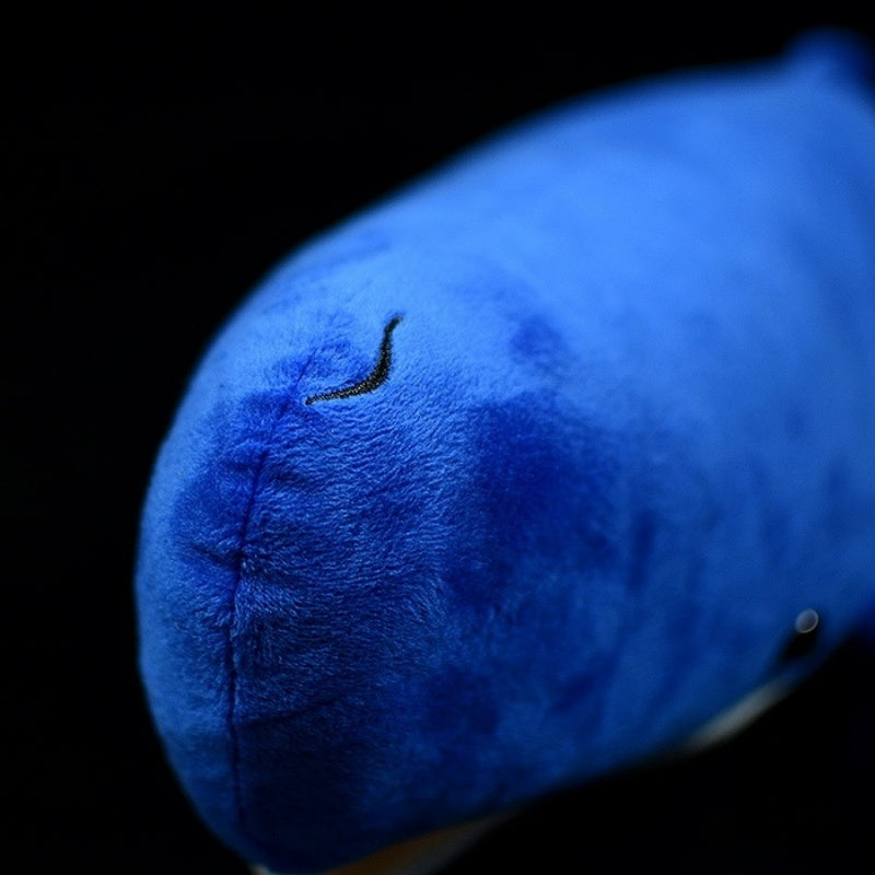 Close-up of the sperm whale plush toy's embroidered head, showcasing fine stitching and soft fabric