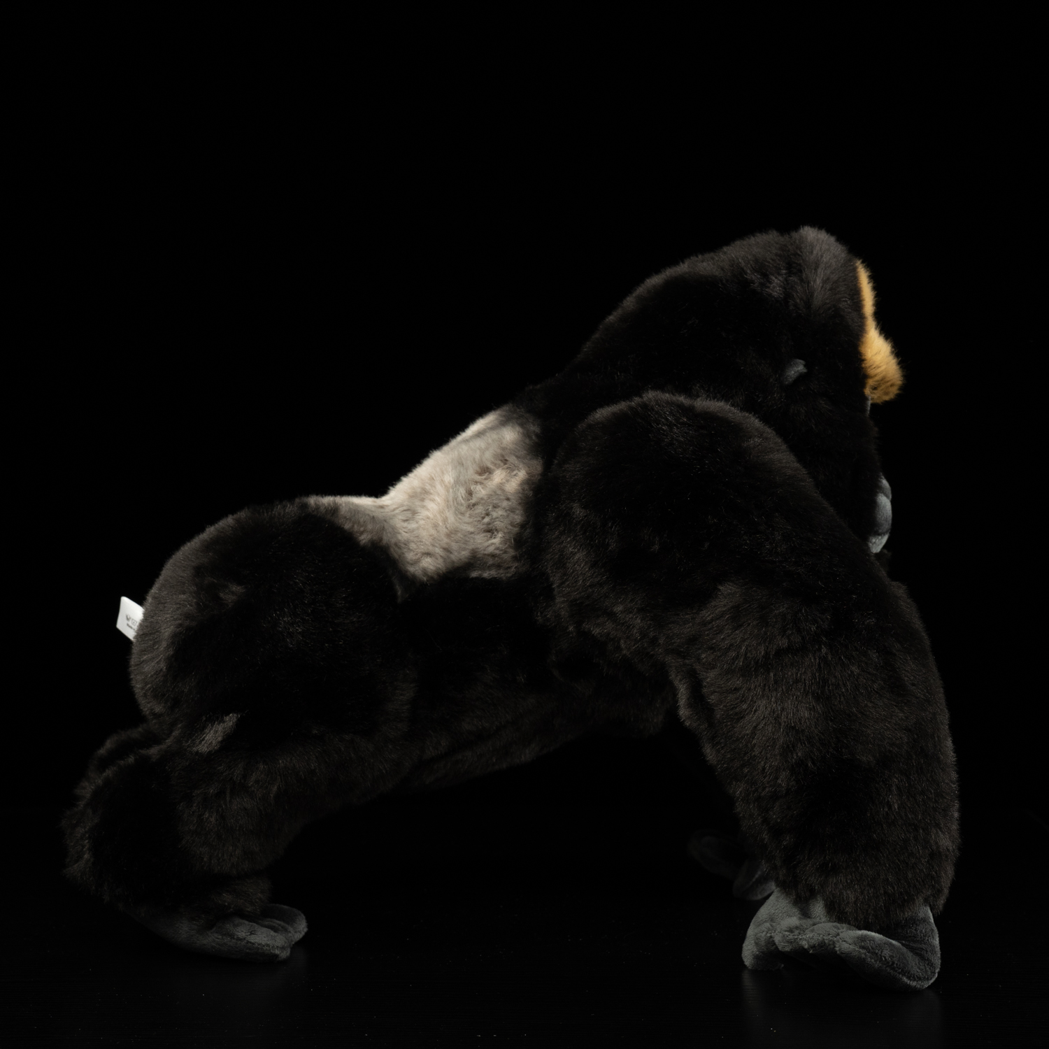 Side profile of a realistic silverback gorilla plush toy, showcasing its powerful build by SoftDaysLab