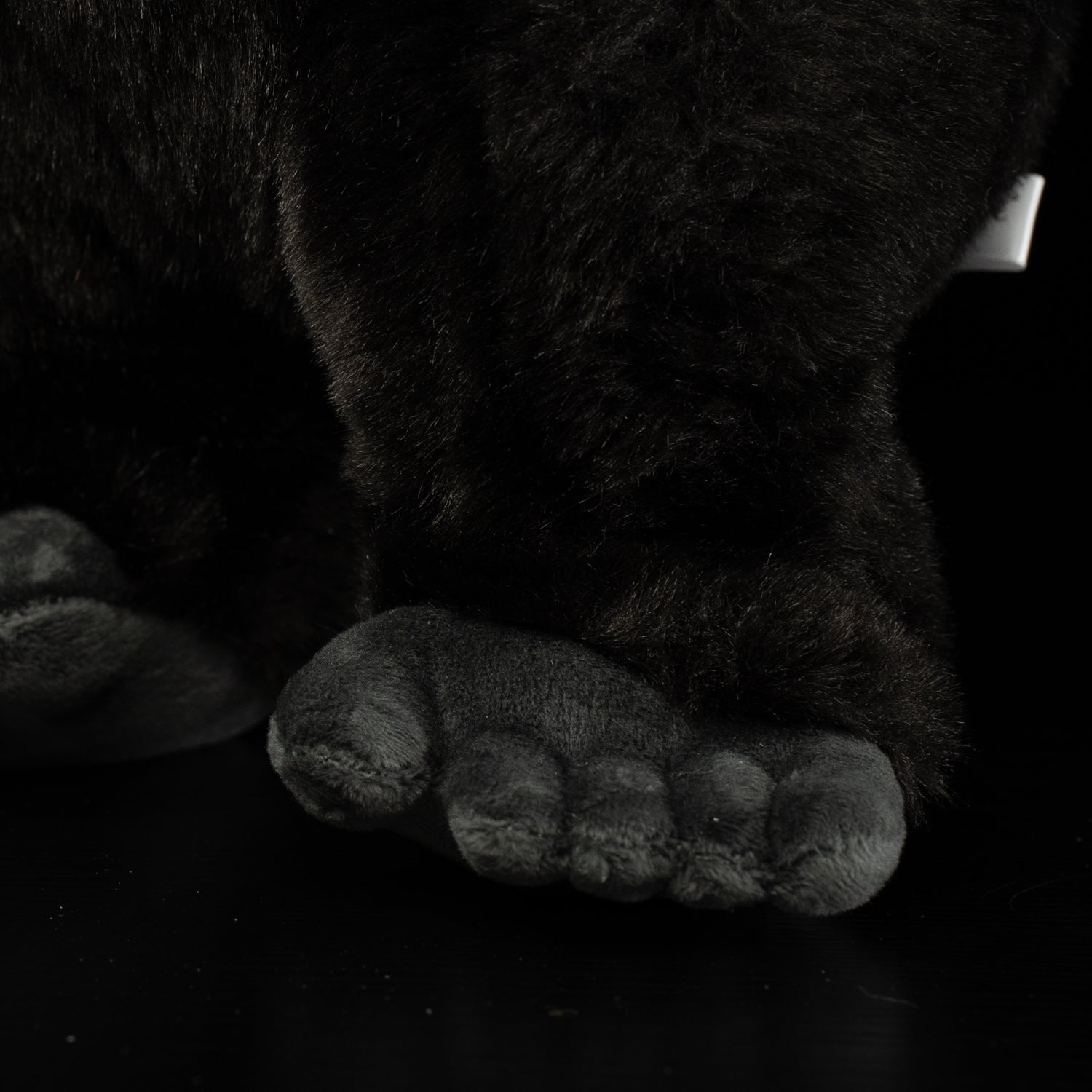 Close-up of the silverback gorilla plush toy’s foot, emphasizing its realistic and huggable features