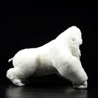 Side profile of an albino gorilla plush toy, showcasing its soft fur and realistic design