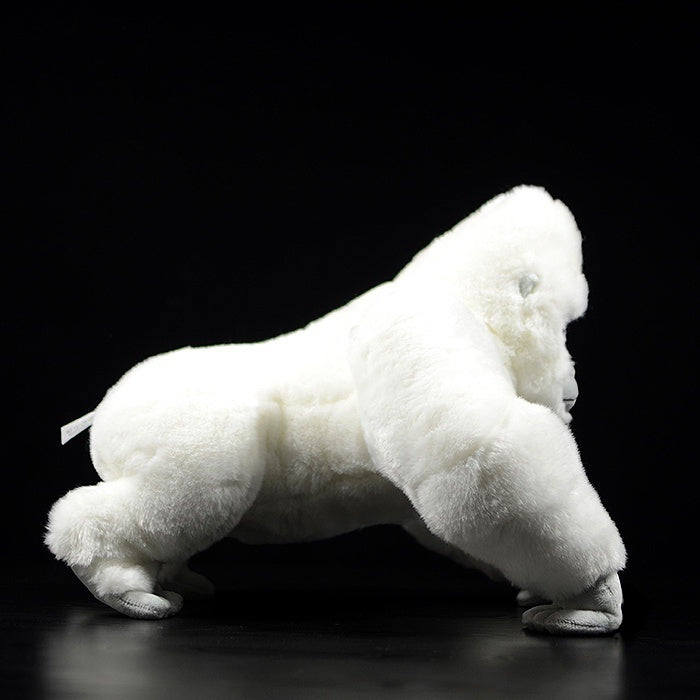 Side profile of an albino gorilla plush toy, showcasing its soft fur and realistic design