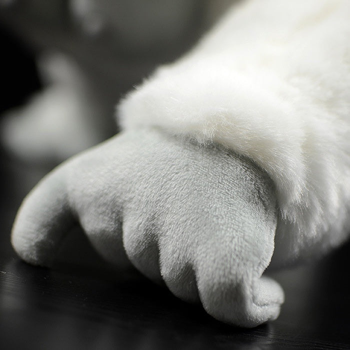 Close-up of the albino gorilla plush toy’s hand, highlighting the soft, detailed design