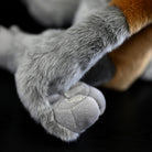 Detailed close-up of the plush Proboscis Monkey's hand, showcasing fine sewing and soft textures