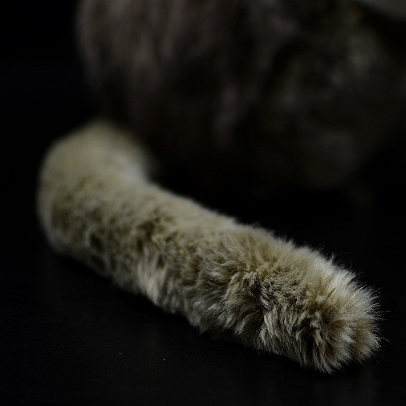 Close-up of the golden snub-nosed monkey plush toy’s fluffy tail, highlighting the soft and lifelike design