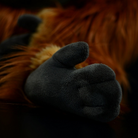 Close-up of orangutan plush toy’s realistic hand, featuring soft and detailed design