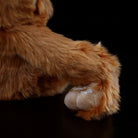Close-up of orangutan plush hand, showcasing delicate stitching and soft fur for realistic jungle play
