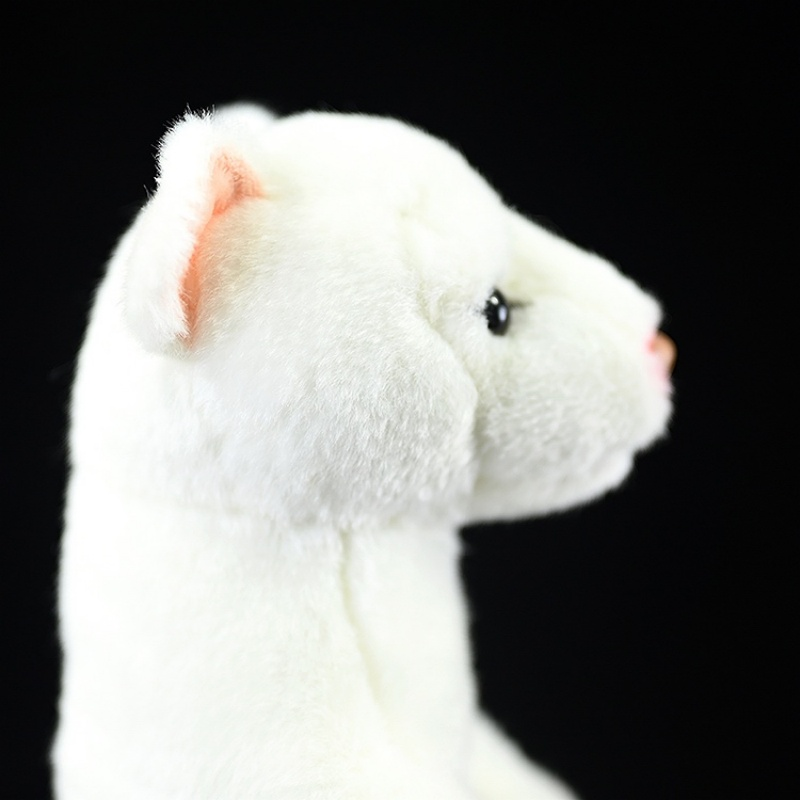 Side view close-up of an ermine plush toy’s head showing its detailed ears and lifelike features