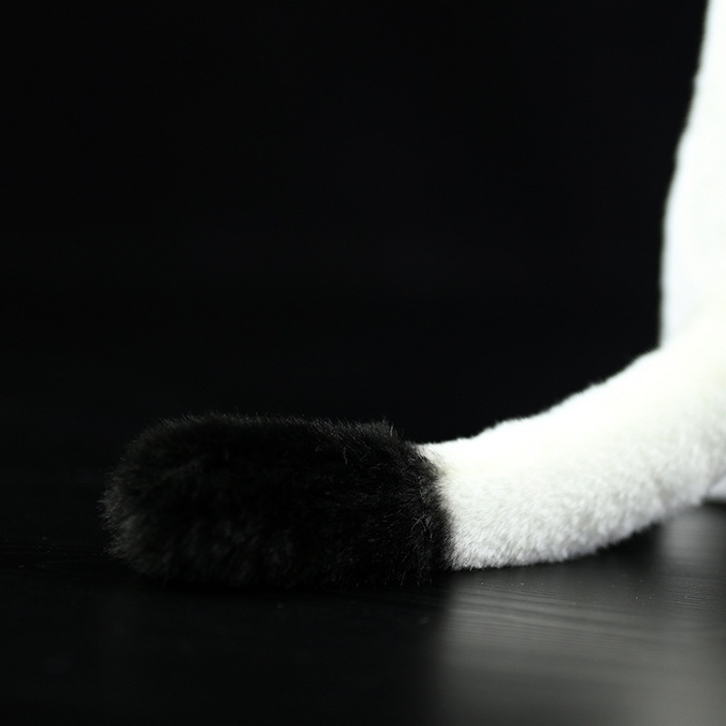 Close-up of the black-tipped tail of a realistic standing ermine plush toy by SoftDaysLab