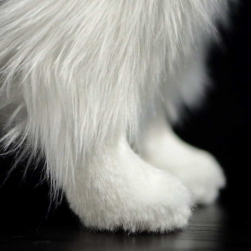 Close-up of Border Collie plush toy's soft white front legs, adding lifelike charm