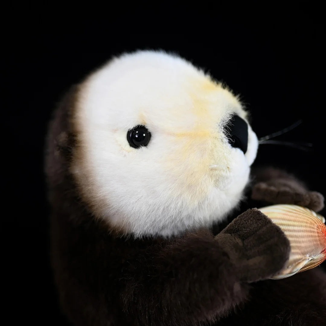 Side view of SoftDaysLab® otter toy's head, emphasizing the hand-stitched details of the plush clam accessory