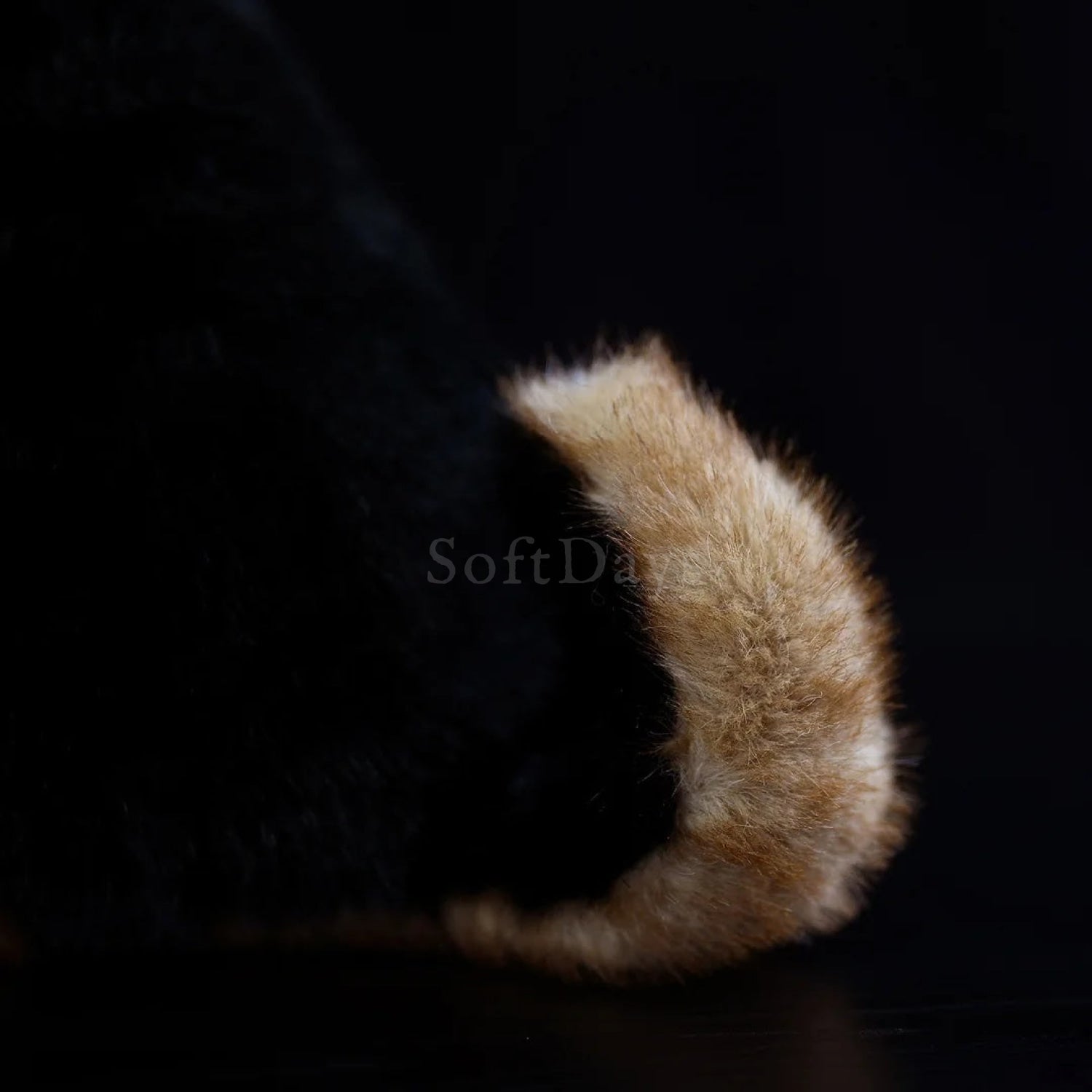 Close-up of lifelike German Shepherd plush toy's tail, showcasing fluffy tan and black realistic fur