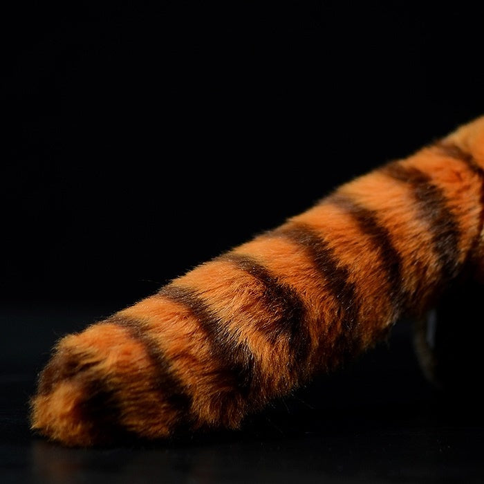 Detailed view of the red panda plush toy's striped tail, designed to replicate the real animal's appearance