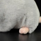 Detailed view of the grey mouse plush toy's paw, showing soft materials and lifelike design