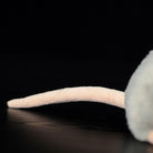 Close-up of the grey mouse plush toy's tail, long and flexible, adding to its realistic appearance