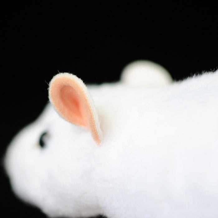 Close-up of the white lab mouse plush toy’s ear, showing detailed craftsmanship and soft texture