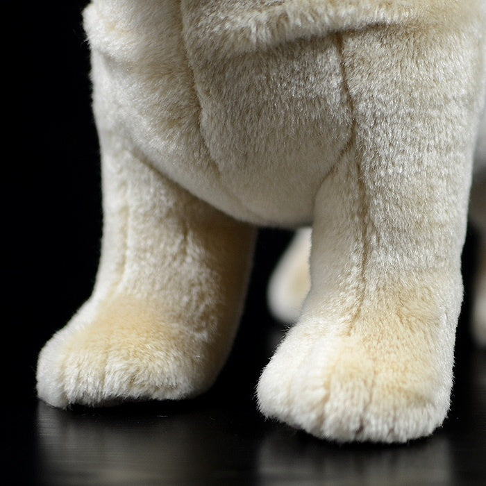 Close-up of the fawn pug plush’s paws, featuring detailed stitching and soft material