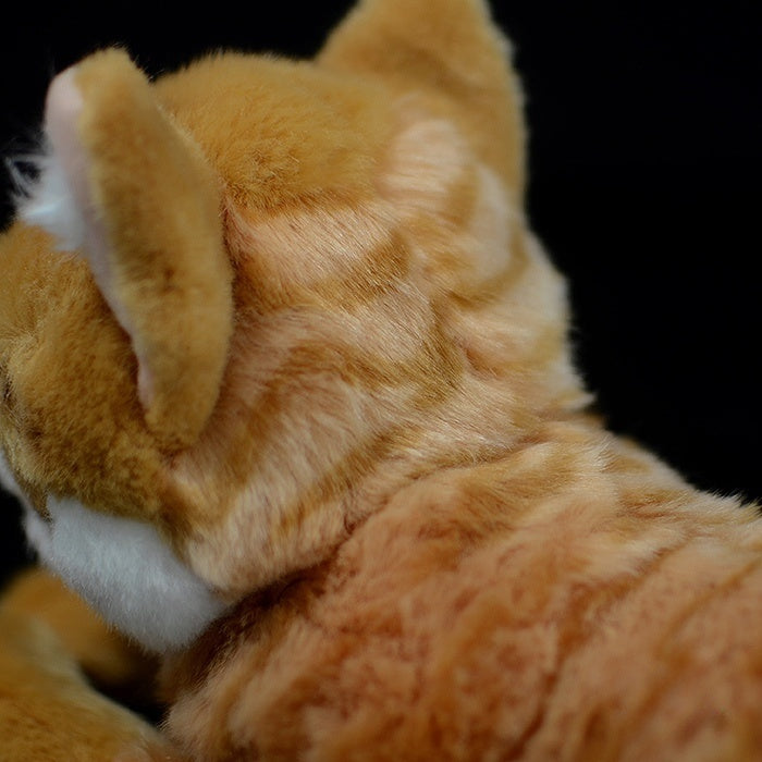 Close-up of the orange tabby plush toy’s detailed fur texture, mimicking a real cat’s coat