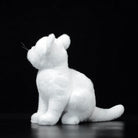 Side profile of a lifelike white cat plush toy, showcasing realistic fur texture and elegant design