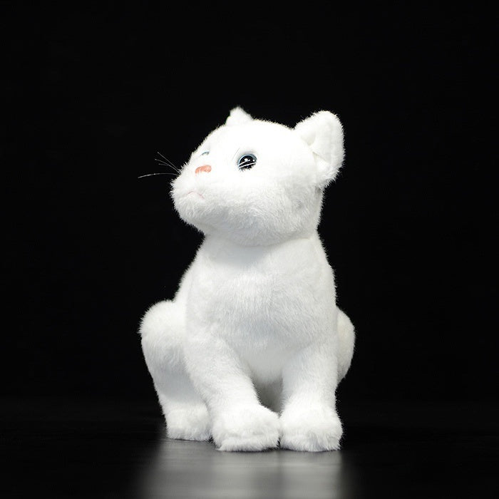 White cat plush toy sitting upright, detailed with a soft coat and captivating blue eyes