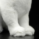 Detailed shot of the white cat plush toy's soft paws, crafted for a lifelike and huggable appearance
