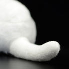 Tail detail of the white cat plush toy, showcasing its fluffy and realistic design for cat lovers