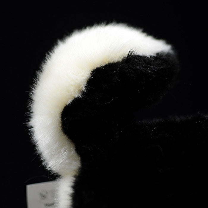 Detailed view of the Black & Tan Shiba Inu plush toy’s curled tail with a fluffy black and white finish