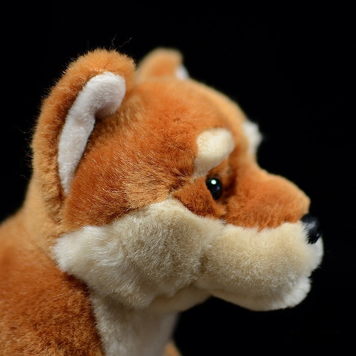 Side facial view of a Shiba Inu plush toy highlighting its cute ears, soft fur, and realistic design