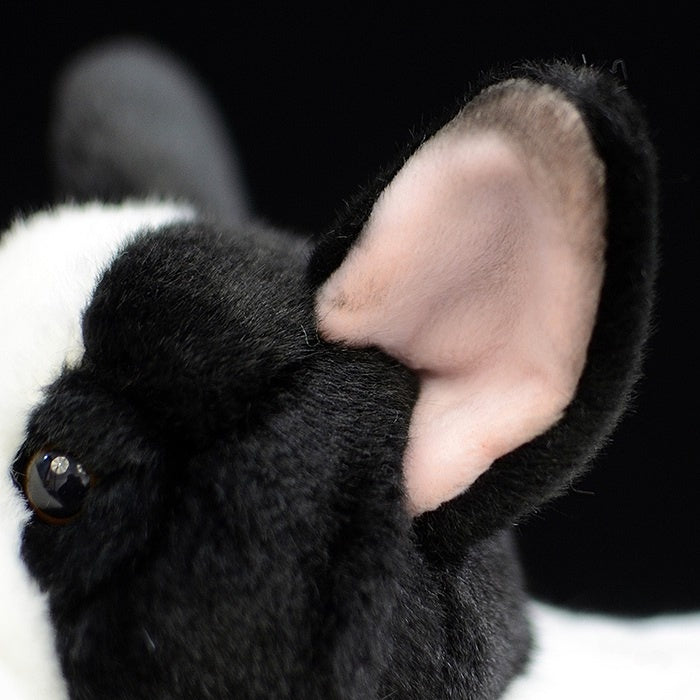 Detailed view of the plush toy's ear, highlighting its soft texture and realistic design