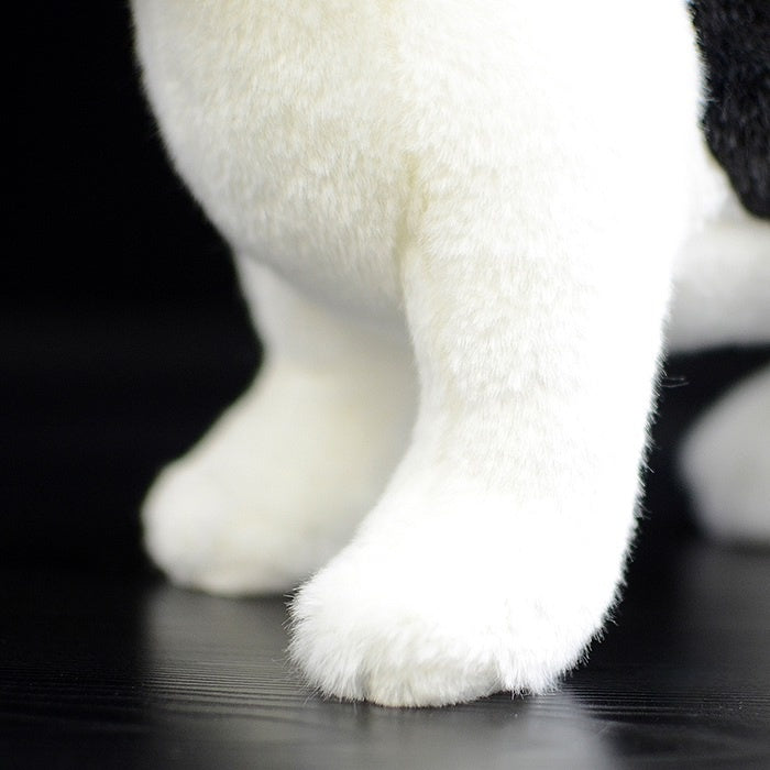 Close-up of the plush toy's front leg, crafted with soft material and a natural look