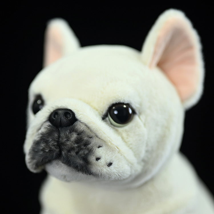 Close-up of a cream French Bulldog plush toy's face, highlighting its realistic nose and adorable expression