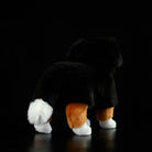 Back view of a Bernese Mountain Dog plush toy, showcasing its fluffy tail and soft tricolor coat