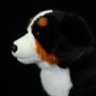 Side close-up of a Bernese Mountain Dog plush, featuring its soft fur and vibrant rust and white markings