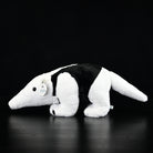 Side view of a Southern Tamandua plush toy, featuring its prehensile tail and soft texture