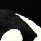 Close-up of a Southern Tamandua plush toy’s paw, showcasing its detailed stitching and soft fabric
