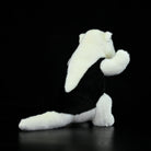 Rear view of a Southern Tamandua stuffed animal, showing its detailed back and fluffy tail