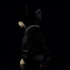 Rear view of a realistic Doberman plush toy, highlighting its sleek black coat and natural posture