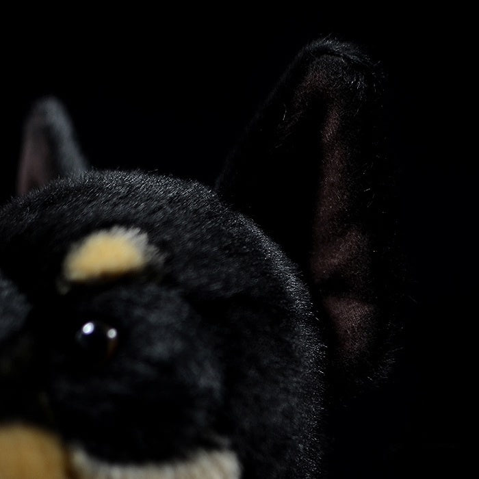 Close-up of the black and tan Doberman plush toy's ears, crafted with realistic and soft material