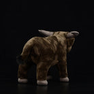 Rear view of a detailed water buffalo plush toy, highlighting its lifelike tail and soft fur design