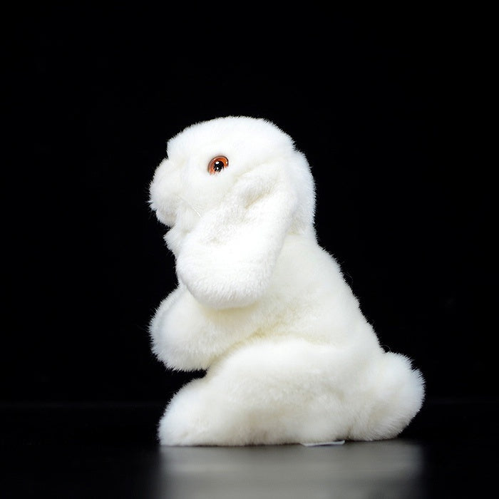 Side view of a white lop-eared rabbit plush, showcasing its lifelike floppy ears and soft texture
