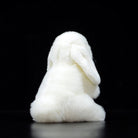 Back view of a soft white lop-eared rabbit plush toy, highlighting its fluffy and realistic design