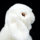Close-up of the white lop-eared rabbit plush's face, with detailed eyes and lifelike fur texture