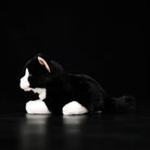 Side profile of a Tuxedo Cat stuffed animal, showcasing its soft fur and realistic sitting pose