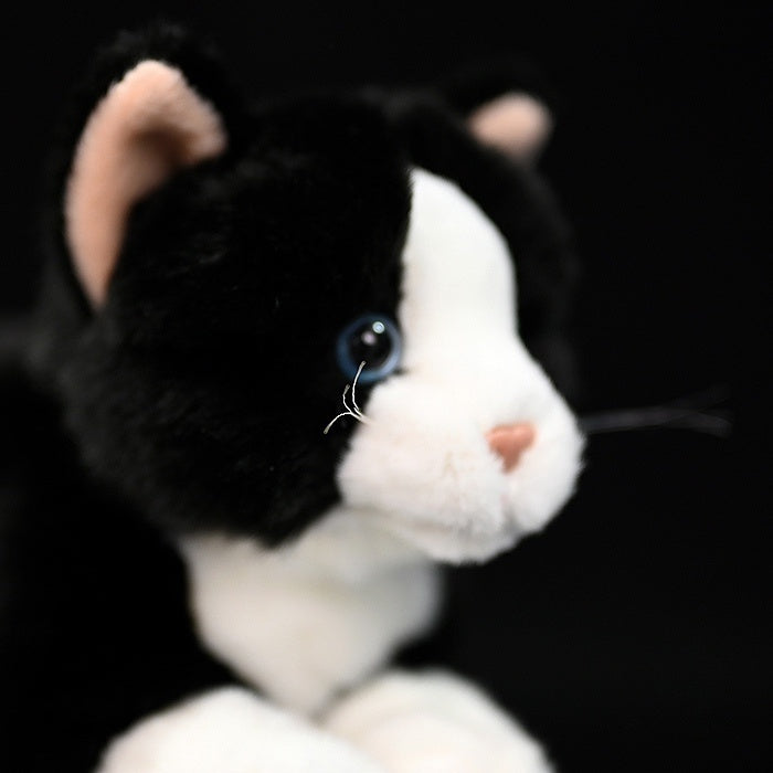 Close-up of the Tuxedo Cat plush toy’s face, featuring detailed eyes and a soft pink nose by SoftDaysLab