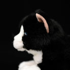 Side close-up of the Tuxedo Cat plush toy, showing its realistic ear and soft black-and-white fur