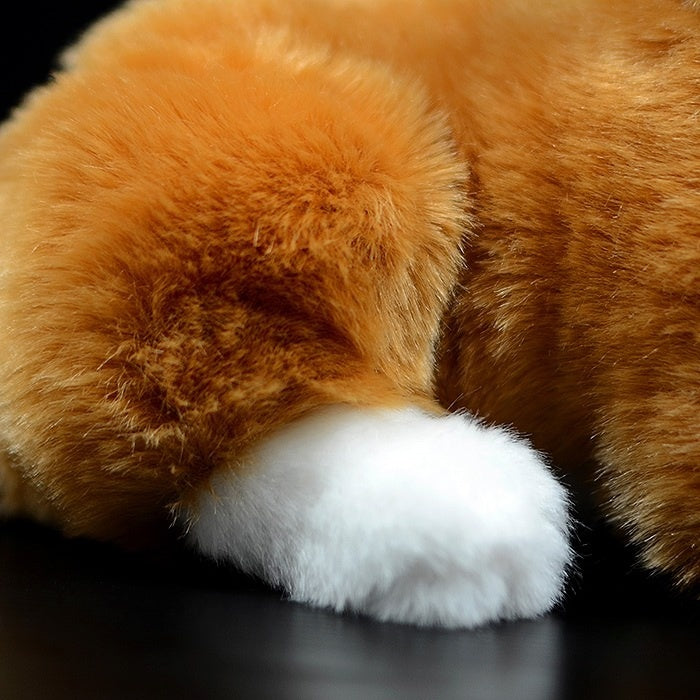 Close-up of Orange Tuxedo Cat plush toy’s tail and white paw detail with soft texture
