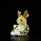 Serval cat plush toy lying down, featuring its distinct large ears and lifelike spotted coat