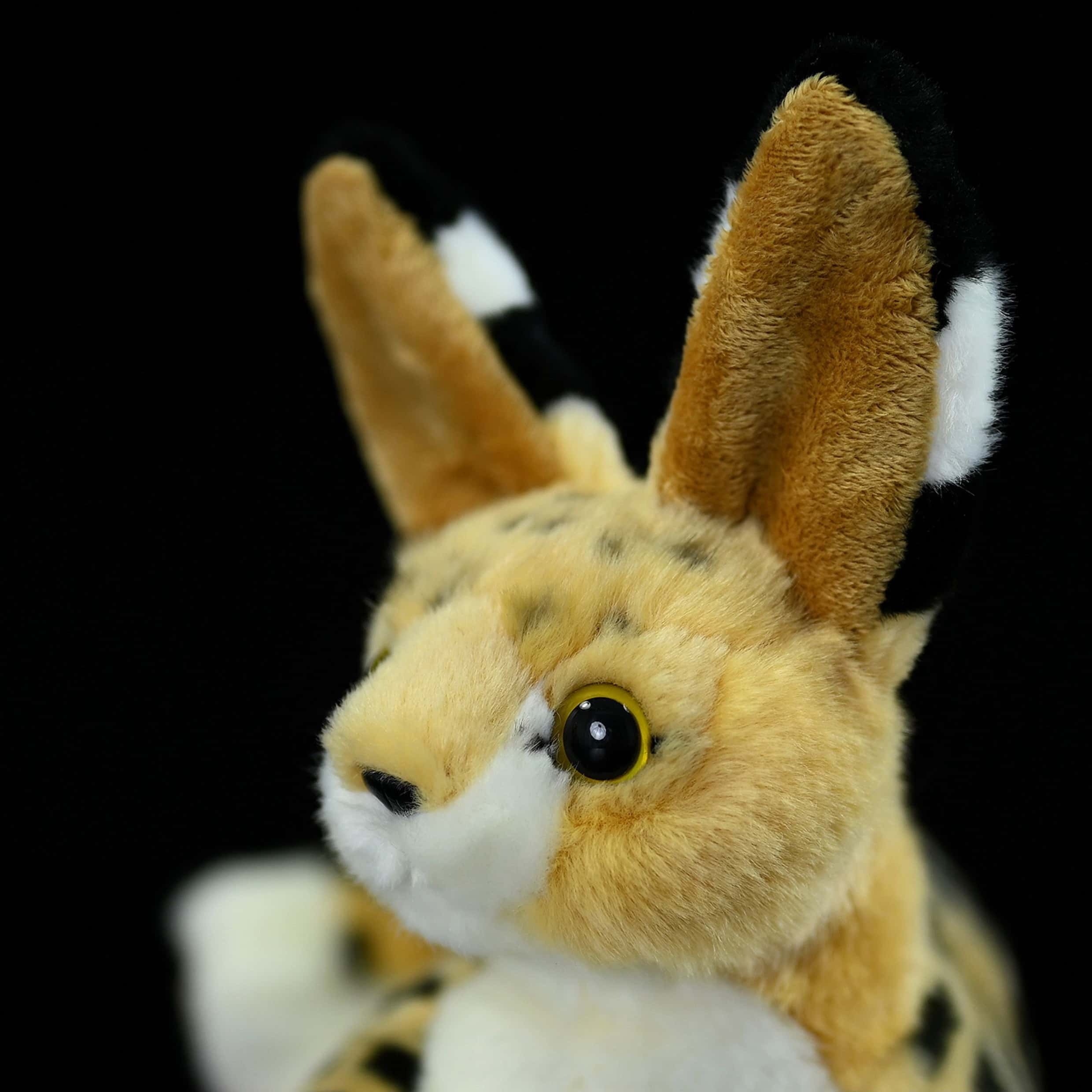Close-up of the serval cat plush toy’s face, emphasizing its detailed ears and realistic eyes